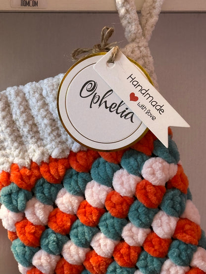 Colorful crocheted stocking with a 'Handmade with Love' tag featuring the name 'Ophelia'. Perfect for all Showgirls!