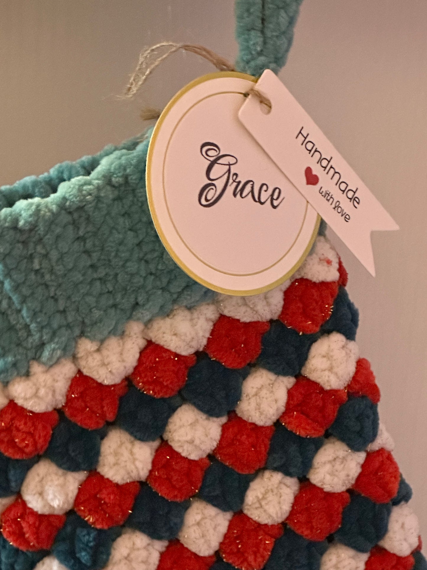 Colorful textured blanket with a 'Handmade with Love' tag and a name tag